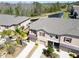 Aerial view of townhomes surrounded by lush greenery and a tranquil pond at 8512 Reedville St, New Port Richey, FL 34654