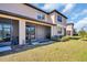 Exterior shot of screened lanai and patio with lush green grass in the back yard at 8512 Reedville St, New Port Richey, FL 34654