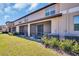 Townhome backyard showing the screened in patios, lawn, and view of the other townhomes at 8512 Reedville St, New Port Richey, FL 34654