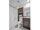 This bathroom offers a shower and tub combination with a granite-topped vanity, and a storage cabinet at 8512 Reedville St, New Port Richey, FL 34654
