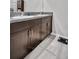 Bathroom with double sink vanity, dark wood cabinets and granite countertops at 8512 Reedville St, New Port Richey, FL 34654