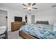 Comfortable bedroom features a ceiling fan, closet, ensuite bathroom, and a dresser with a TV at 8512 Reedville St, New Port Richey, FL 34654