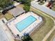Aerial view of a sparkling community pool with ample seating, perfect for relaxation and recreation at 8512 Reedville St, New Port Richey, FL 34654