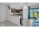 The well-lit kitchen includes stainless steel appliances and overlooks a view of the water at 8512 Reedville St, New Port Richey, FL 34654