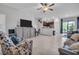 Bright open-concept living area with tile floors seamlessly connects the kitchen, dining, and outdoor patio at 8512 Reedville St, New Port Richey, FL 34654