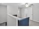 Upstairs loft area with neutral carpet, ceiling fan, and access to additional bedrooms and storage at 8512 Reedville St, New Port Richey, FL 34654