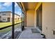 A view of the screened patio from inside the home, with a view of the yard and a neighbor's home at 8512 Reedville St, New Port Richey, FL 34654