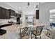 Granite countertops and a kitchen island provide seating and a view to the dining area at 867 Vino Verde Cir, Brandon, FL 33511