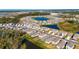 Aerial view showcases the house's location within the community and near the pond at 9008 Waxwing Way, Parrish, FL 34219