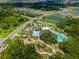Aerial view of the community amenities including a resort-style pool and splash pad at 9008 Waxwing Way, Parrish, FL 34219