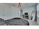 Well lit bedroom with modern finishes including luxury vinyl flooring, a contemporary light fixture and modern trim at 9008 Waxwing Way, Parrish, FL 34219