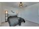 A contemporary bedroom featuring neutral tones, a comfortable bed, and stylish lighting at 9008 Waxwing Way, Parrish, FL 34219