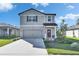 Charming two-story home with a well-manicured lawn and inviting front entrance at 9008 Waxwing Way, Parrish, FL 34219