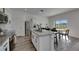 Well-lit kitchen with granite countertops, stainless steel appliances, and seamless access to the dining area at 9008 Waxwing Way, Parrish, FL 34219