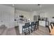 Modern kitchen features stainless steel appliances, a granite-topped island, and stylish barstool seating at 9008 Waxwing Way, Parrish, FL 34219