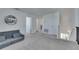 Bright loft area features neutral gray carpet, a cozy gray sofa, and ample access to bedrooms and staircase at 9008 Waxwing Way, Parrish, FL 34219