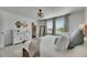 The main bedroom features a large bed, windows, and decor at 9008 Waxwing Way, Parrish, FL 34219