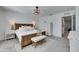 The main bedroom features a large bed, a mirror, bench, and a dresser at 9008 Waxwing Way, Parrish, FL 34219