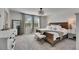 The main bedroom features a large bed, a mirror, bench, and a dresser at 9008 Waxwing Way, Parrish, FL 34219