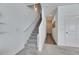 Carpeted staircase with white walls and a long hallway with wood floors at 9008 Waxwing Way, Parrish, FL 34219