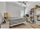 Bright bedroom featuring a wooden floor, bed, desk, and built-in shelving, offering a cozy and functional space at 9151 Melody Cir, Port Charlotte, FL 33981