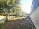 Well-maintained backyard with mature trees and a wooden fence at 9308 Pinero St, Spring Hill, FL 34608