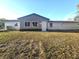 Exterior view of the home showcasing the backyard and updated siding at 9308 Pinero St, Spring Hill, FL 34608