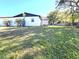 Spacious backyard with lush lawn and mature trees providing shade at 9308 Pinero St, Spring Hill, FL 34608
