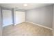 A neutrally painted bedroom with light tile flooring and a closet for storage at 9308 Pinero St, Spring Hill, FL 34608