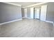 The bedroom features a closet with sliding doors, tile floors, neutral paint, and large baseboards at 9308 Pinero St, Spring Hill, FL 34608