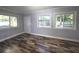 Bright bedroom with hardwood-style tile flooring and lots of natural light from the windows at 9308 Pinero St, Spring Hill, FL 34608