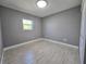 The bedroom features light tile floors, neutral walls, and a closet with sliding doors at 9308 Pinero St, Spring Hill, FL 34608