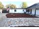View of the front yard featuring a brick pathway leading to the front door and a manicured lawn at 9308 Pinero St, Spring Hill, FL 34608