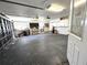 Spacious garage featuring overhead lighting, a workbench, and storage solutions at 9308 Pinero St, Spring Hill, FL 34608