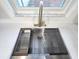 Modern kitchen sink features a stainless steel basin, granite countertop, and a gooseneck faucet at 9308 Pinero St, Spring Hill, FL 34608