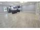 Open-concept kitchen and living space with tile flooring and stylish fixtures, great for entertaining at 9308 Pinero St, Spring Hill, FL 34608