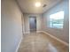 A bright room featuring light-colored tile flooring and ample natural light at 9308 Pinero St, Spring Hill, FL 34608