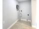 Utility room with tile flooring, showcasing water heater equipment at 9308 Pinero St, Spring Hill, FL 34608