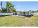 Wide shot of backyard with covered patio, shed, and grassy area at 10309 108Th Ave, Largo, FL 33773