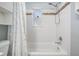 Shower-tub with decorative tile accents and shower curtain at 10309 108Th Ave, Largo, FL 33773