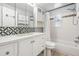 Updated bathroom features white vanity with storage, shower-tub, and decorative tile accents at 10309 108Th Ave, Largo, FL 33773