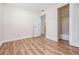 Bedroom with wood-look floors, closet, and neutral walls. Doorway leads to other rooms at 10309 108Th Ave, Largo, FL 33773