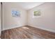 Bright bedroom featuring wood-look floors and two windows for ample natural light at 10309 108Th Ave, Largo, FL 33773