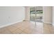 Bright room with neutral tile flooring and sliding glass doors to outdoor space at 10309 108Th Ave, Largo, FL 33773