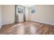 Bright bedroom with wood-look floors and two windows providing natural light at 10309 108Th Ave, Largo, FL 33773