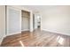 Bedroom features wood-look floors and closet with sliding doors. Doorway view to bathroom at 10309 108Th Ave, Largo, FL 33773