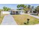 Lovely home with a well-maintained lawn and a convenient circular driveway at 10309 108Th Ave, Largo, FL 33773