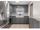 Updated kitchen with stainless steel appliances, grey cabinets, and a farmhouse sink at 10309 108Th Ave, Largo, FL 33773