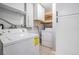 Functional laundry area with washer, dryer, storage cabinets, and shelving at 10309 108Th Ave, Largo, FL 33773