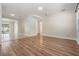 Spacious area with wood floors, leading to a bright, tiled sunroom and hallway at 10309 108Th Ave, Largo, FL 33773